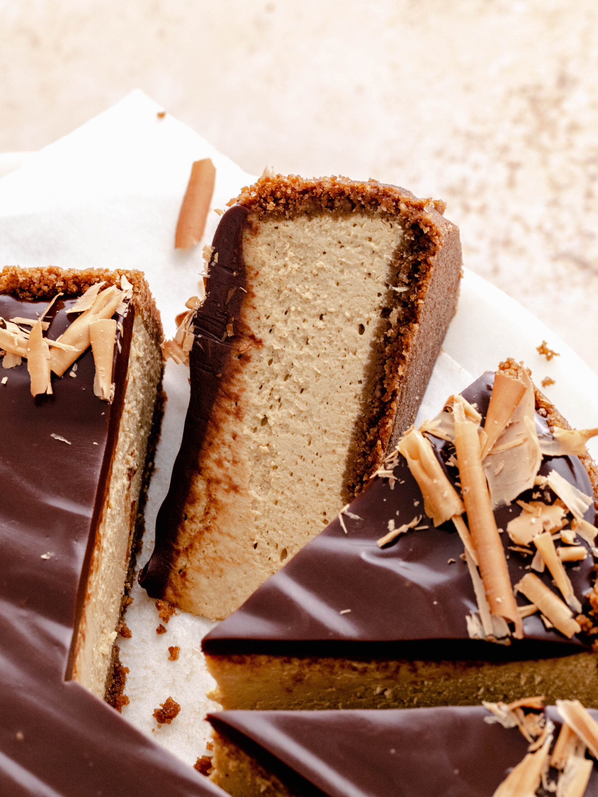 Espresso cheesecake cut into slices with on of the titled to side. 