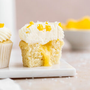 Soft coconut cupcake, filled with a mango curd and topped with a delicious coconut and vanilla buttercream