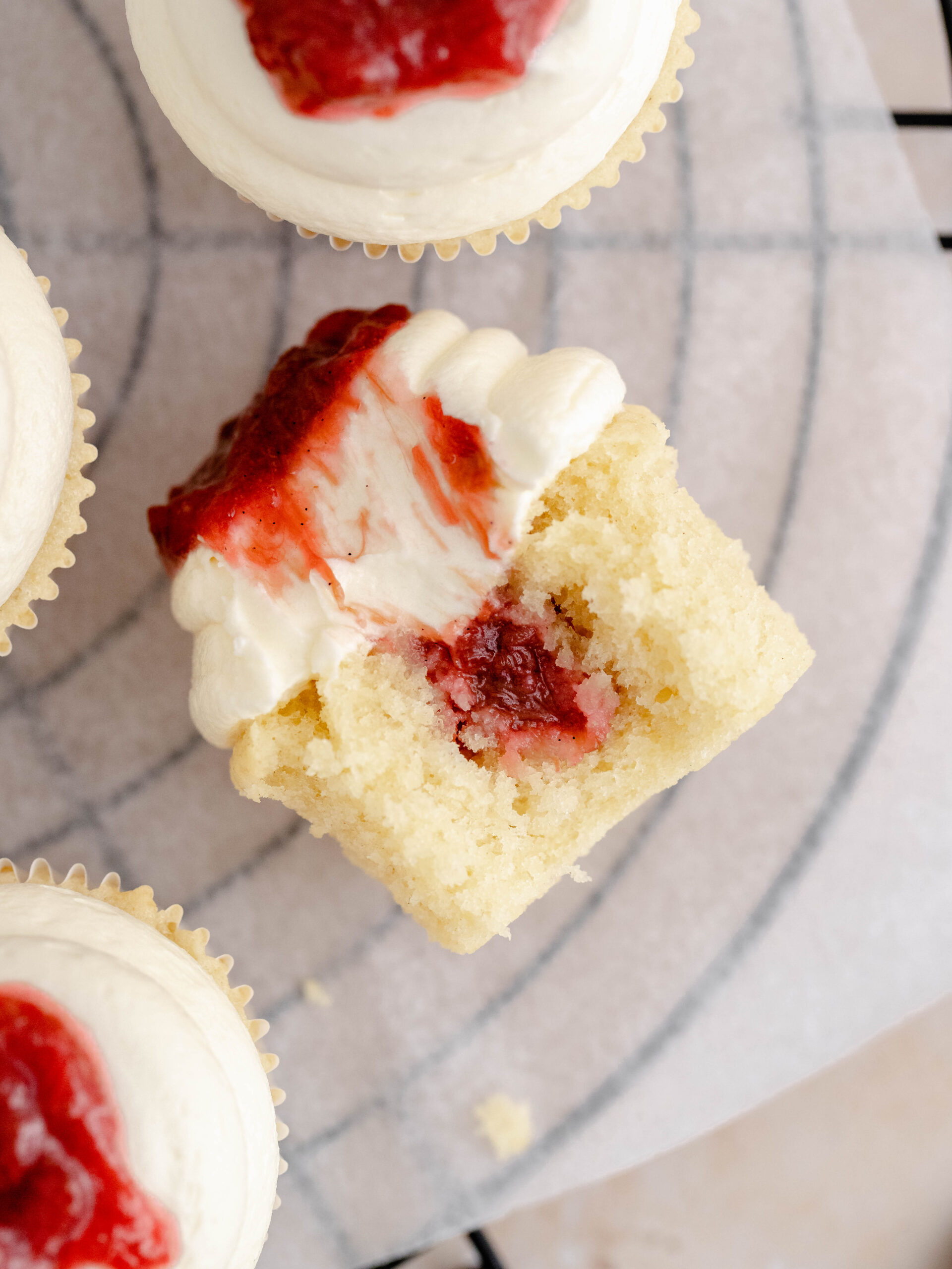 A rhubarb and almond cupcake on a tray.