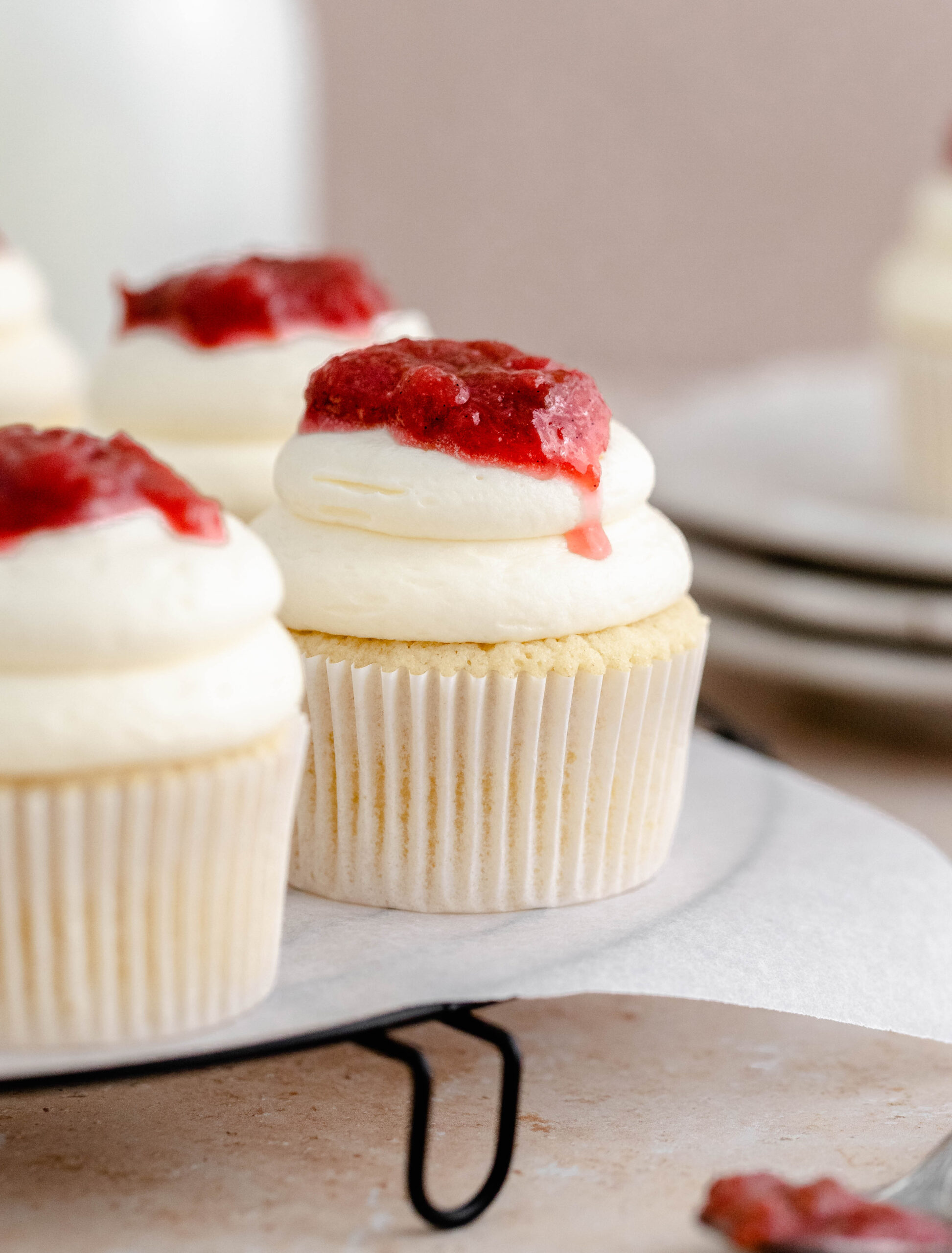 Rhubarb and almond cupcakes on a cake stand. 