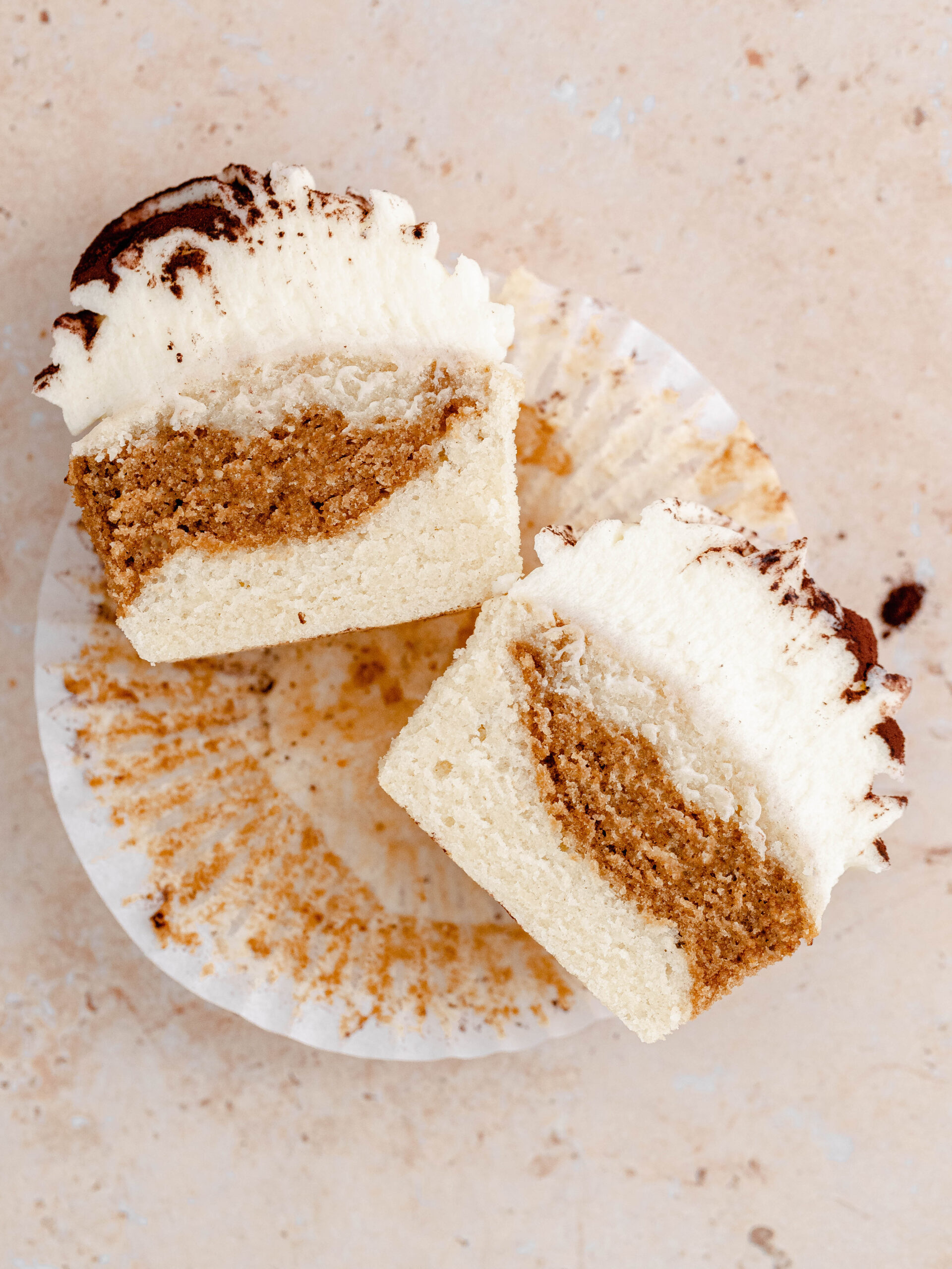 A Tiramisu cupcake cut in half.