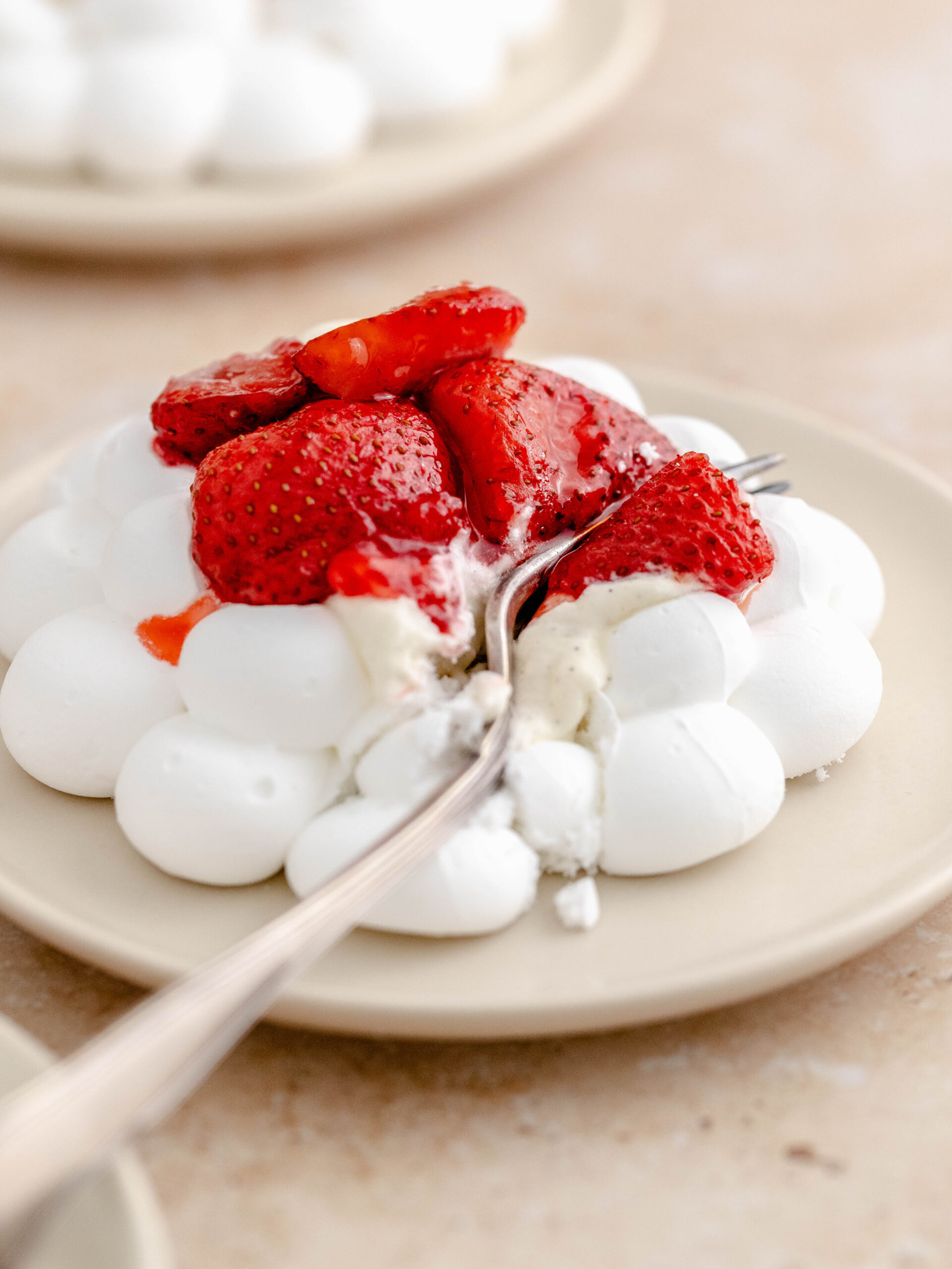 A baked strawberry meringue nest on a plate.
