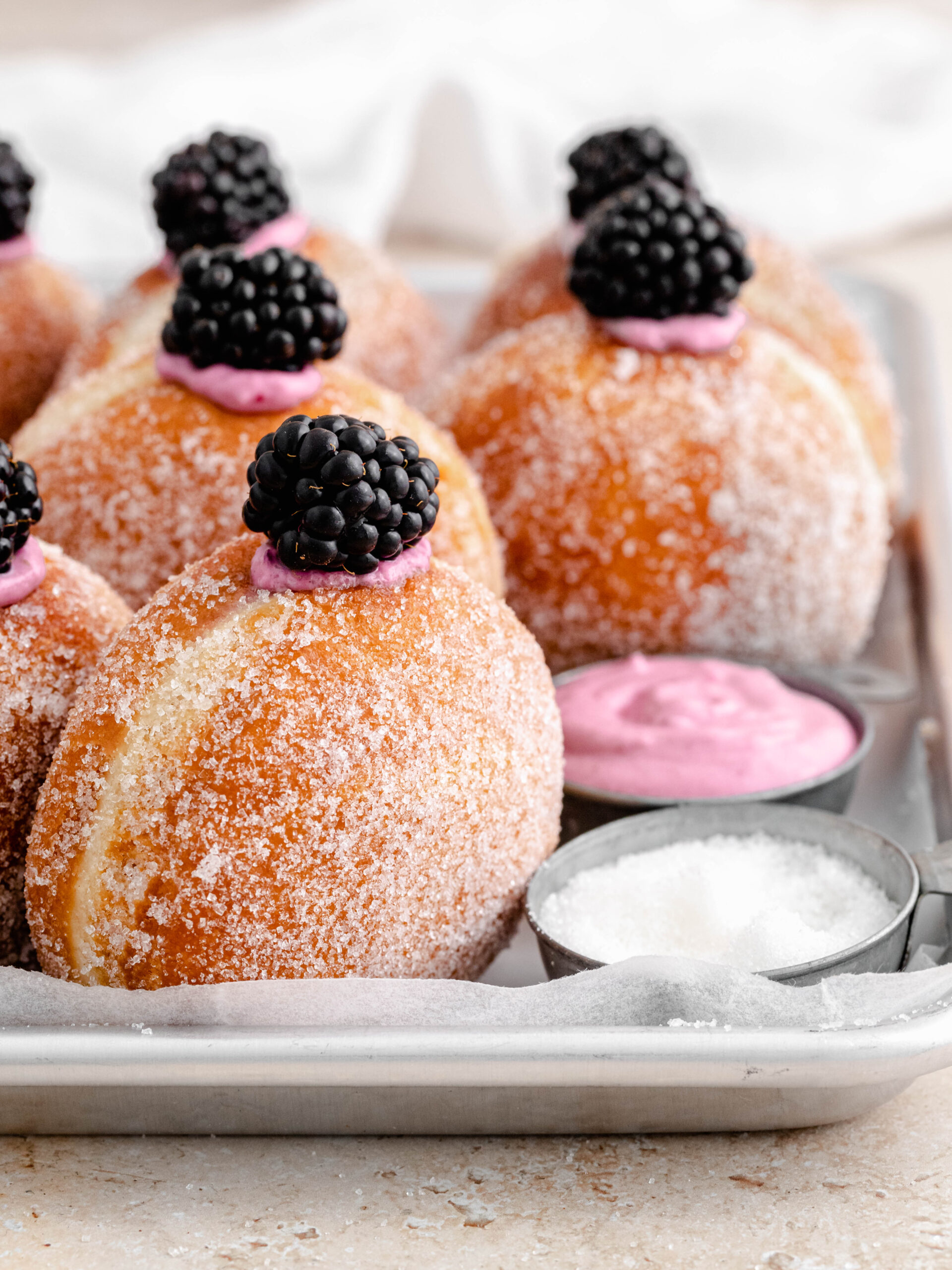 Rows of blackberry cheesecake donuts.