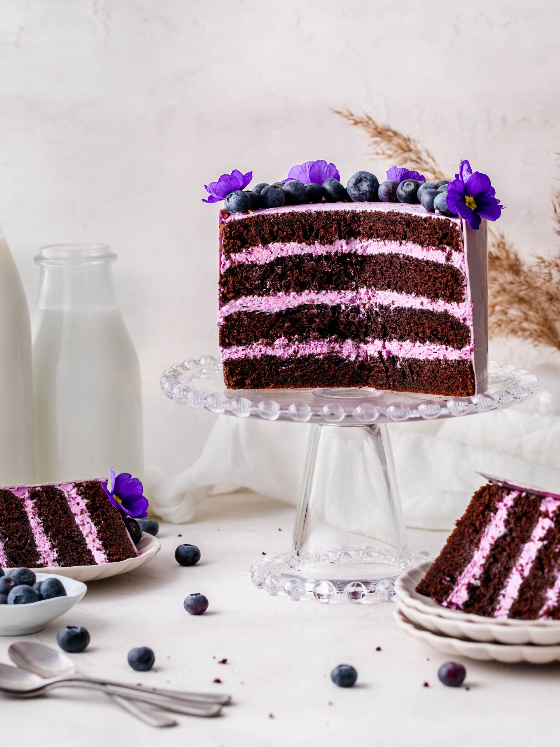 Blueberry Cream Cheese Chocolate Cake on a cake stand.