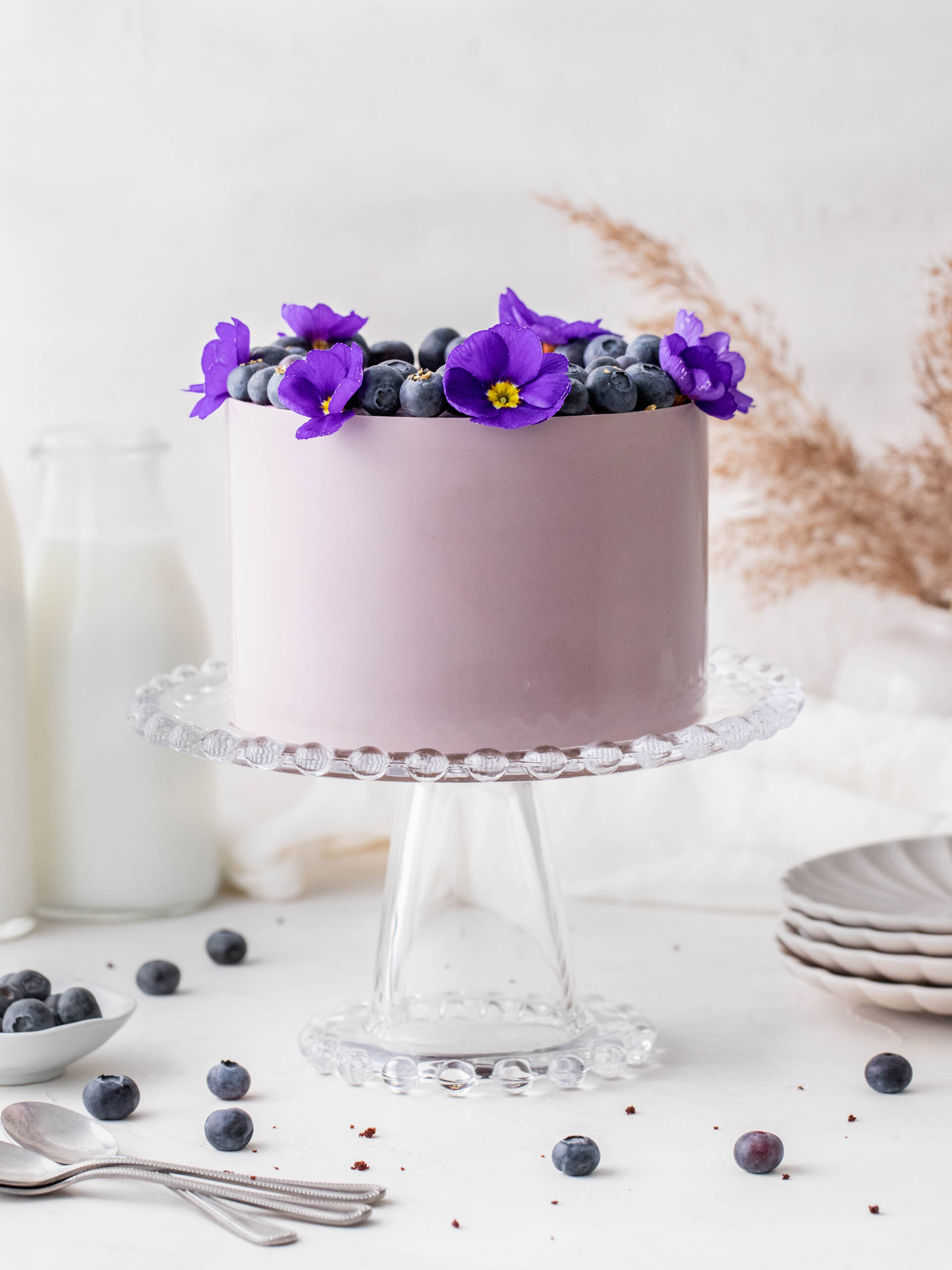 Blueberry Cream Cheese Chocolate Cake on a cake stand.