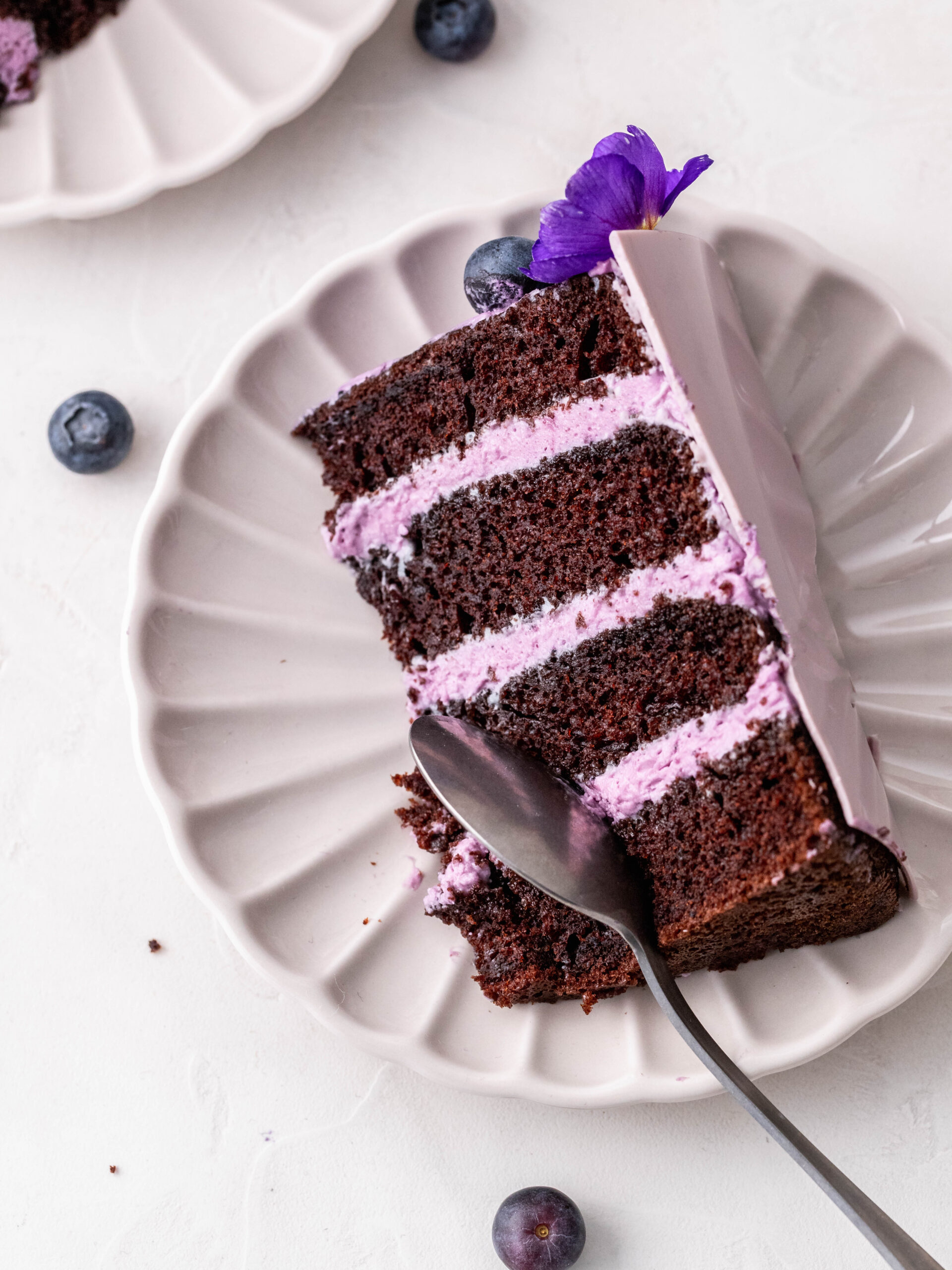 Blueberry Cream Cheese Chocolate Cake slice on a plate.