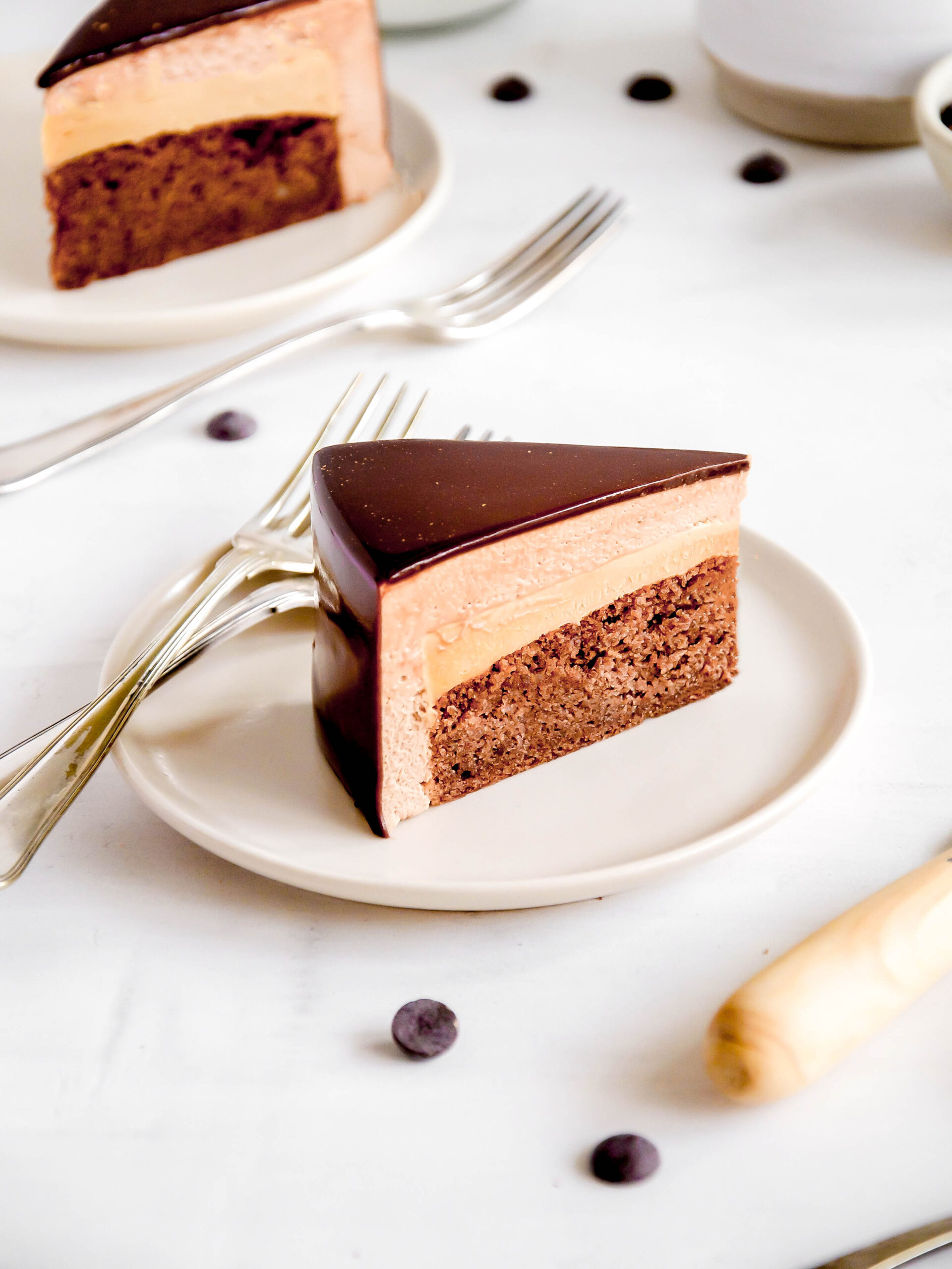 chocolate and caramel mousse cake slice on a plate.