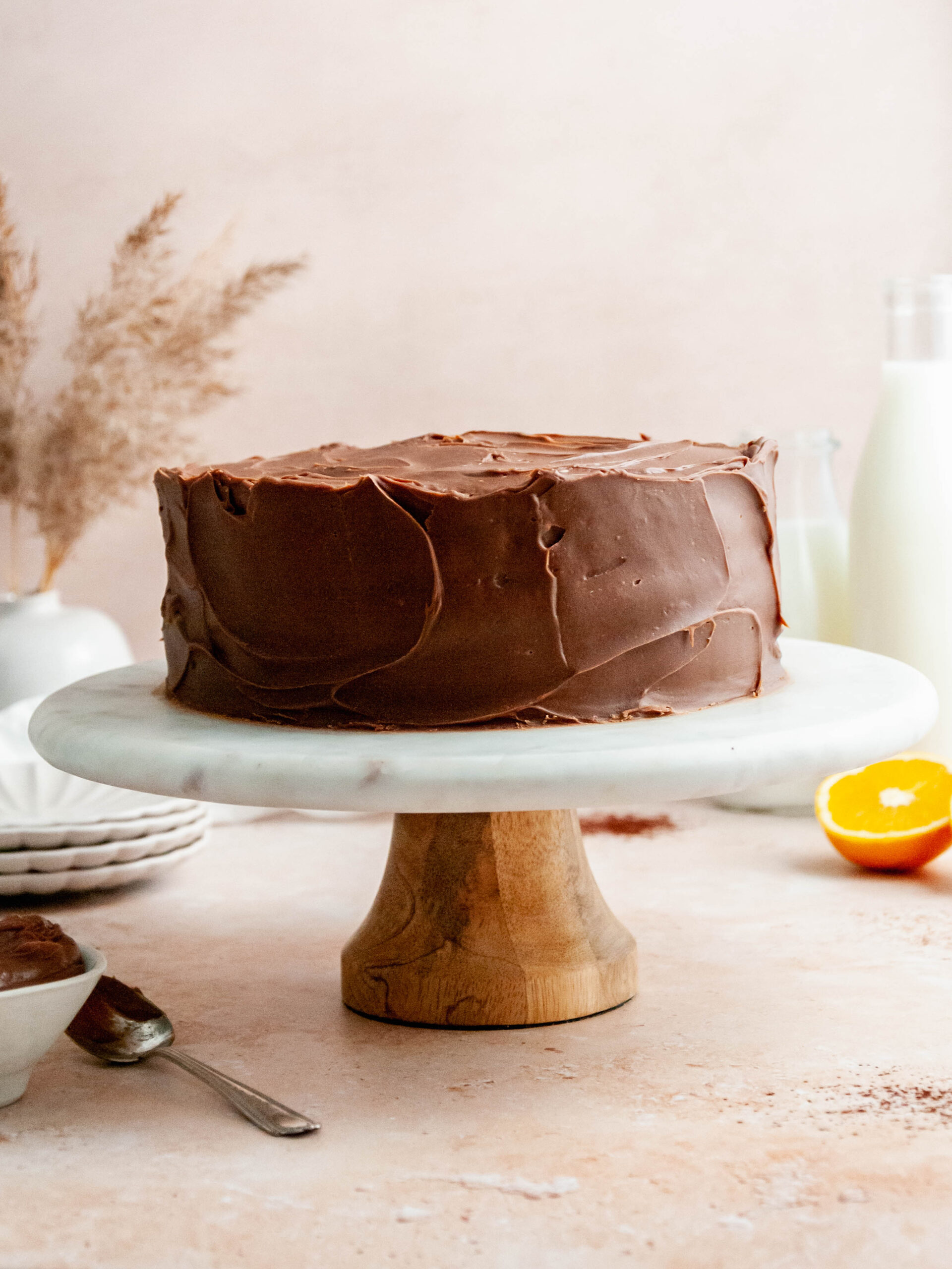 Chocolate orange cake on a cake stand.