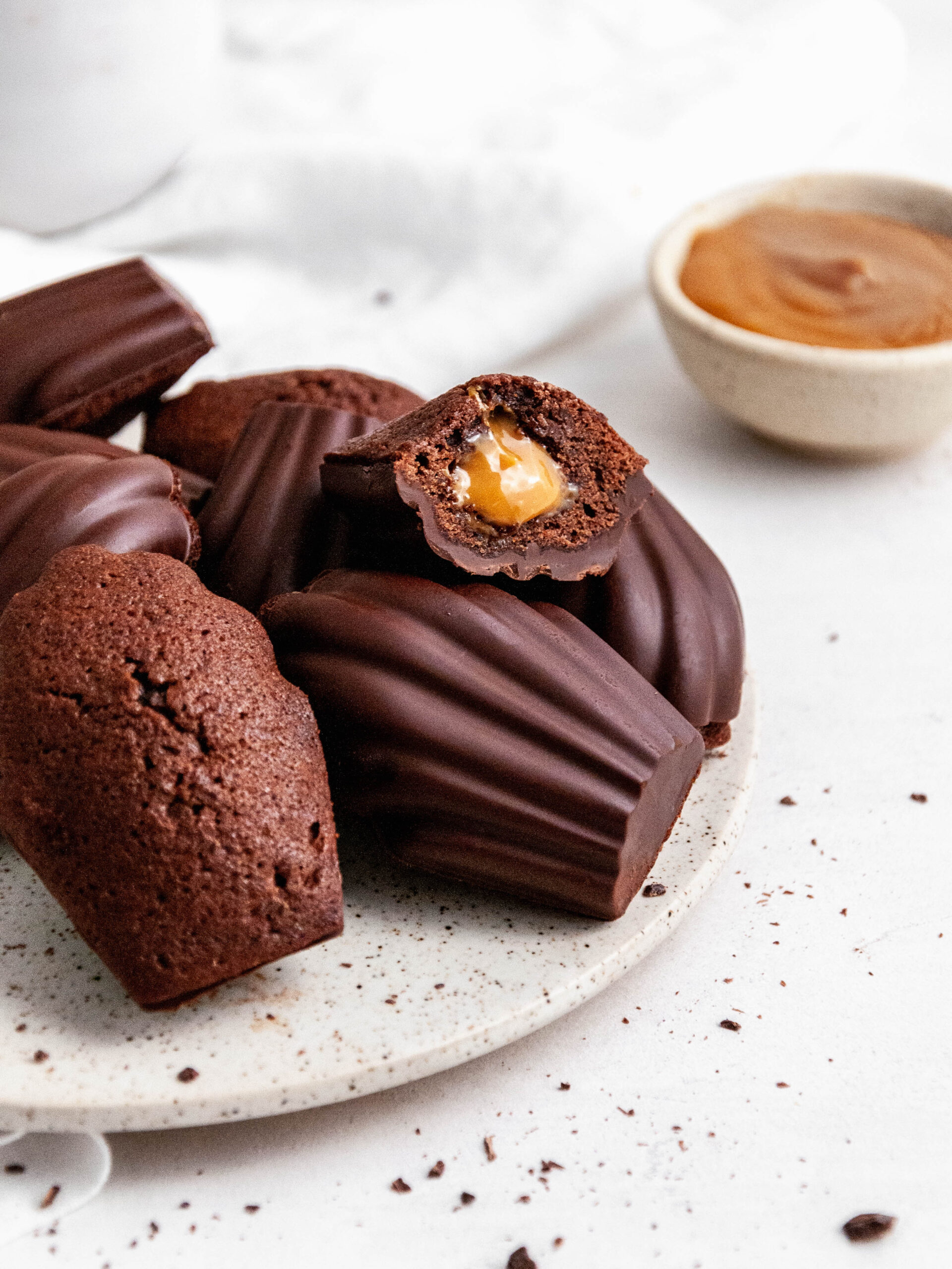 chocolate madeleines with Dulce de Leche on a plate.