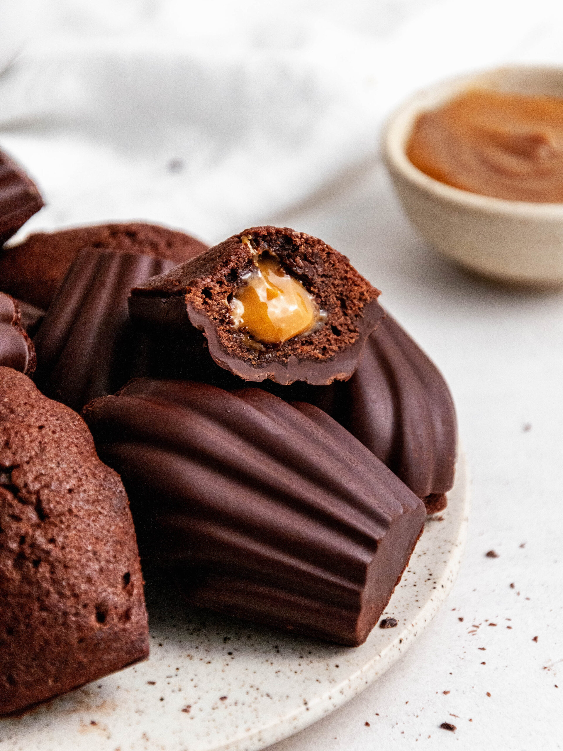 Chocolate madeleines with Dulce de Leche cut in half.