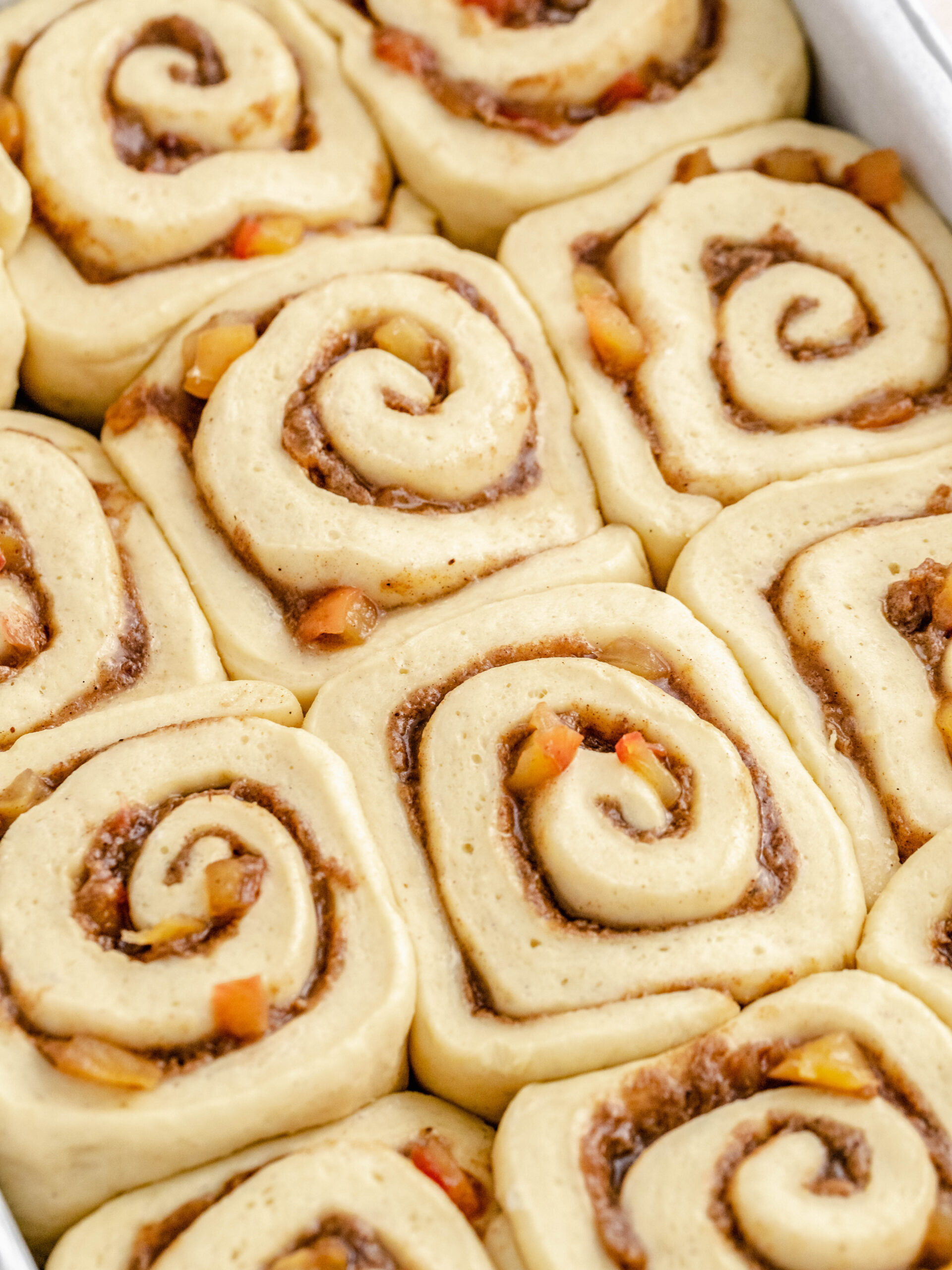Cinnamon rolls with apple pie filling before they are baked.