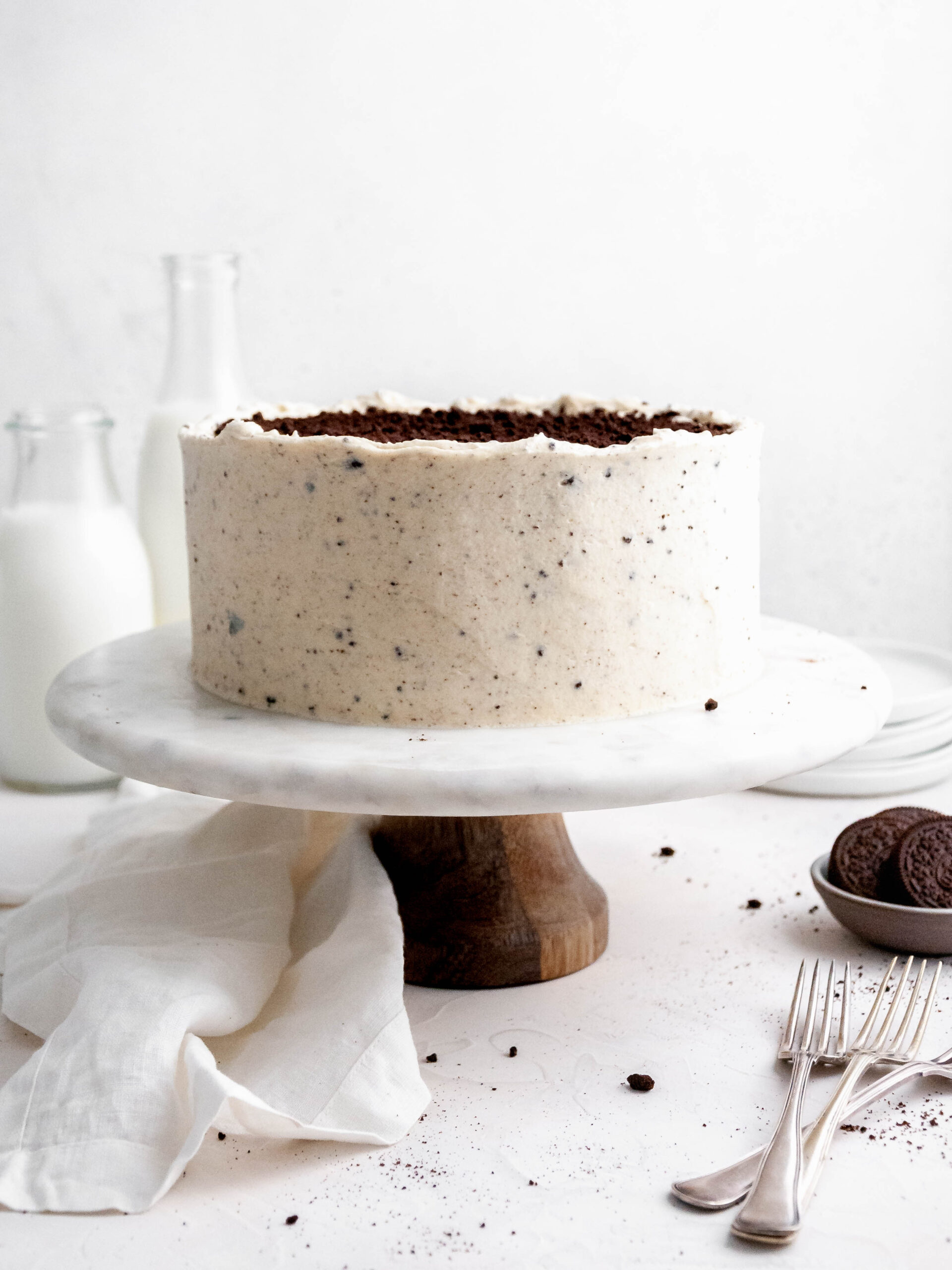 Oreo layer cake on a cake stand.