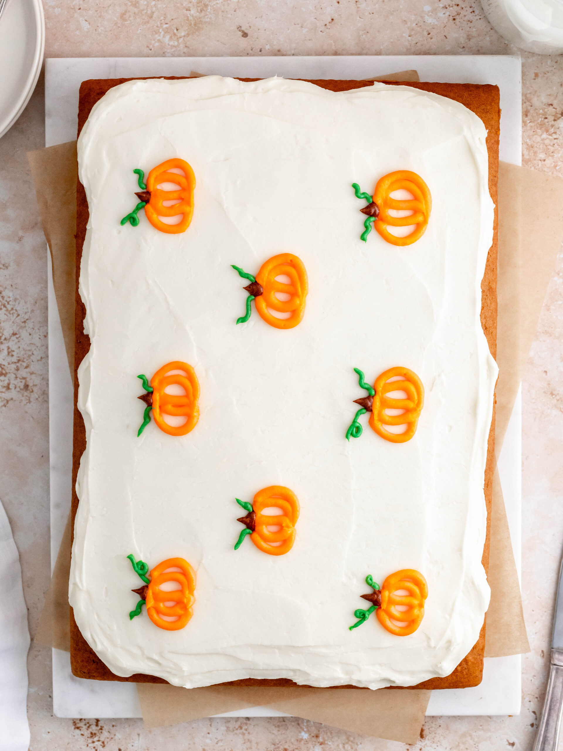 Pumpkin sheet cake on a serving tray.