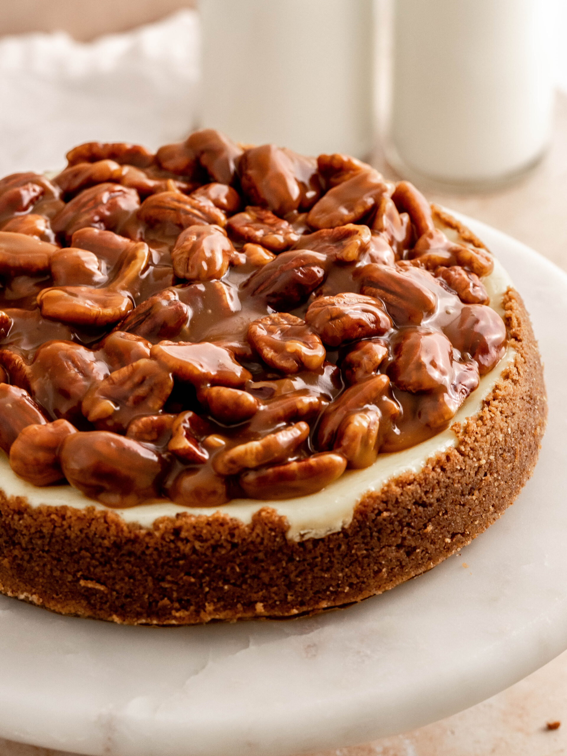 Step 8. Add the caramel and pecans on top of the cheesecake and enjoy.