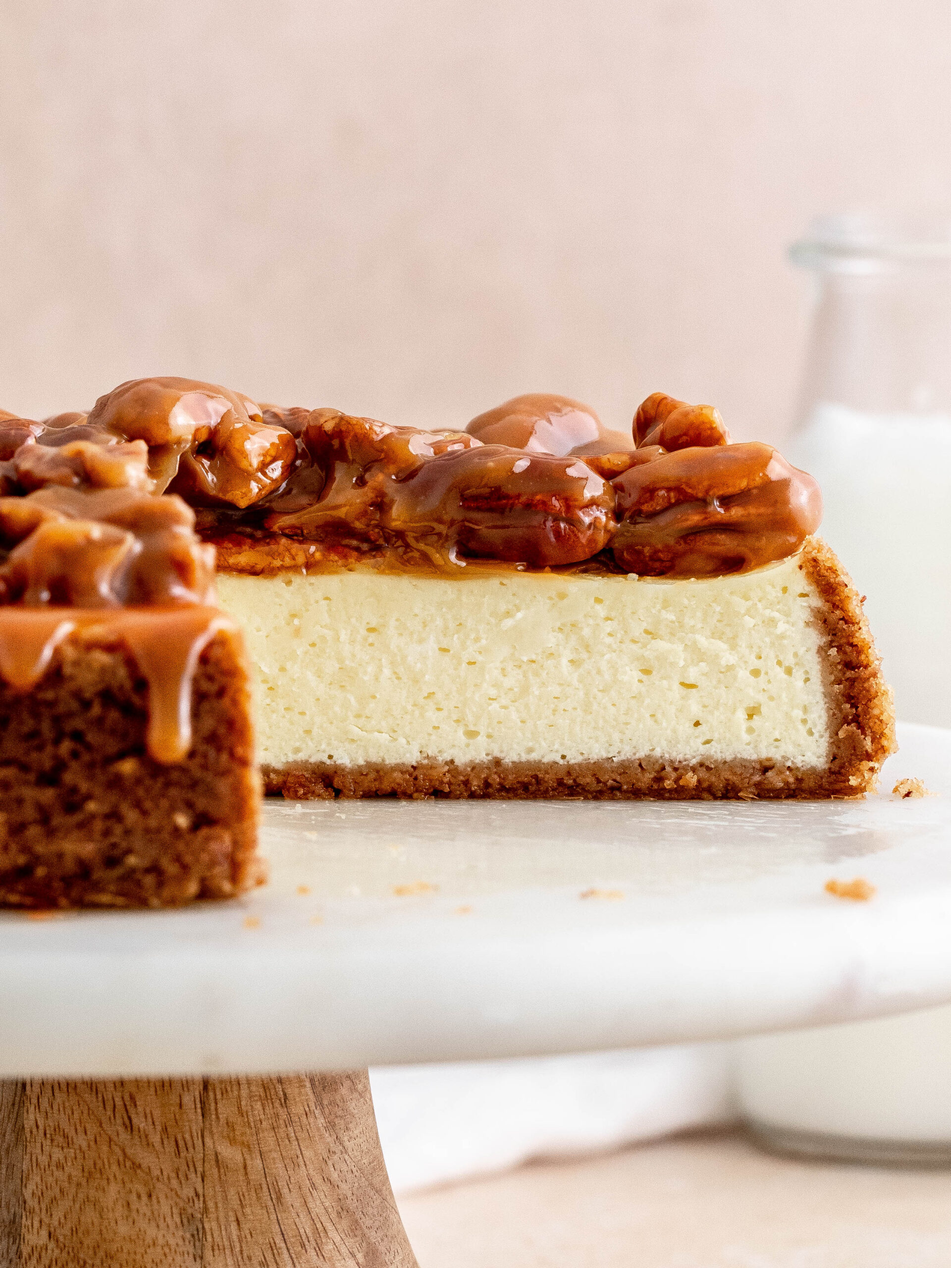Caramel pecan cheesecake on a cake stand