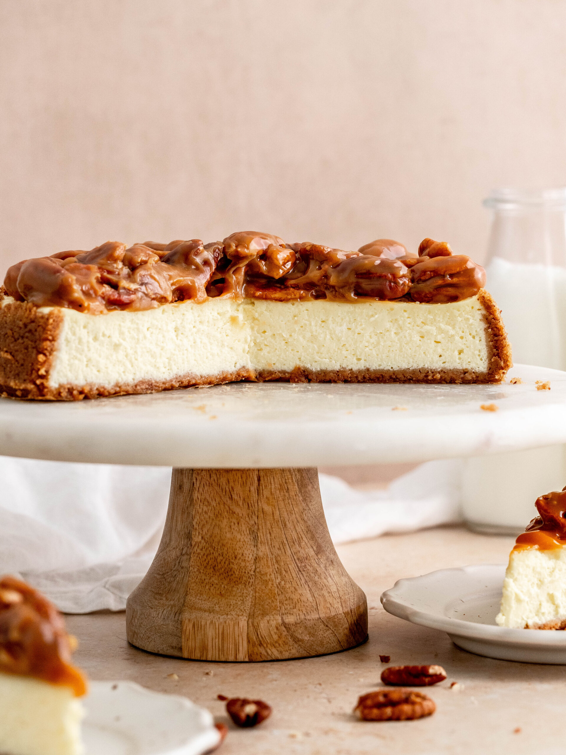 Caramel pecan cheesecake on a cake stand