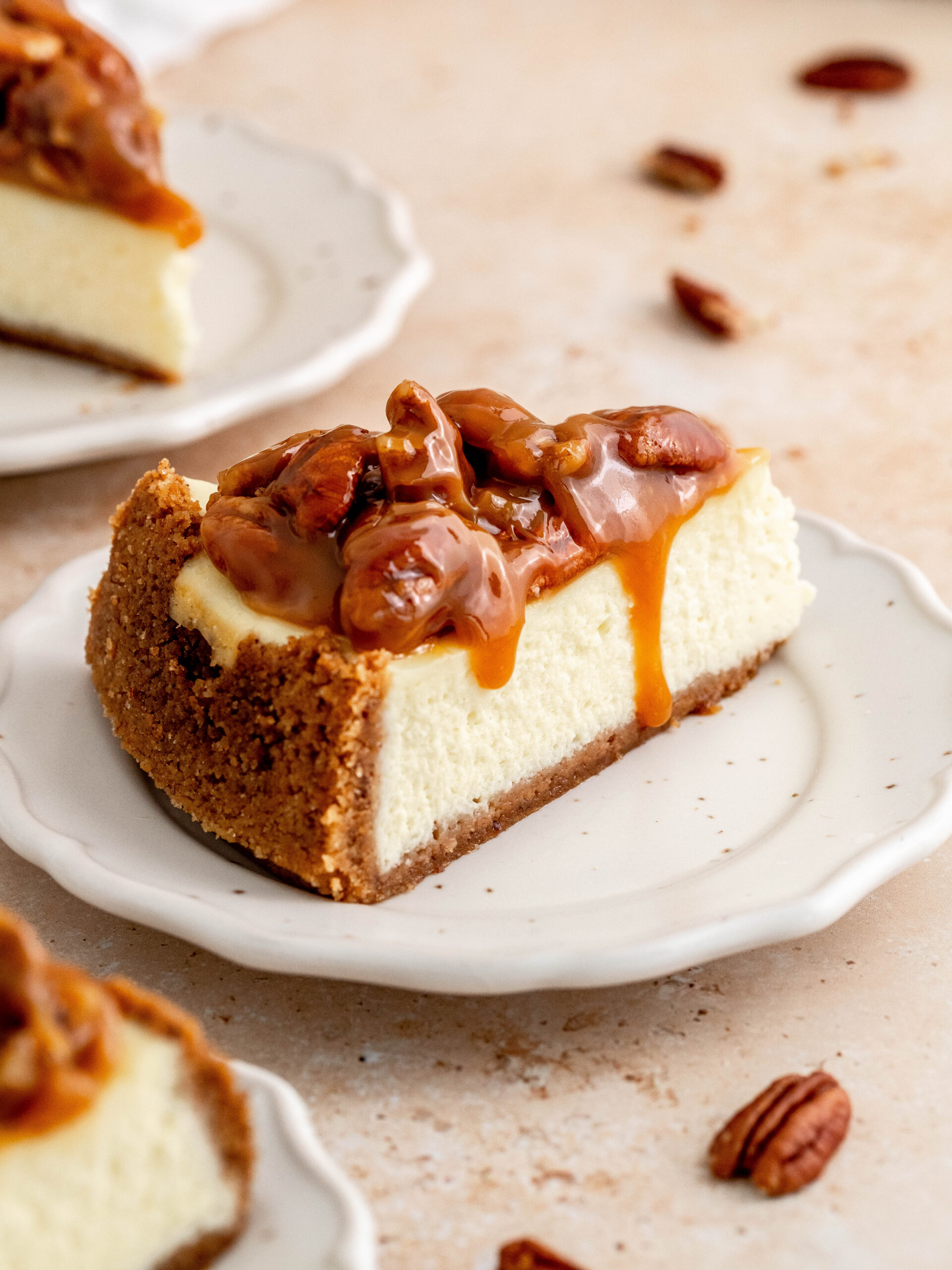 A slice of caramel pecan cheesecake on a plate.