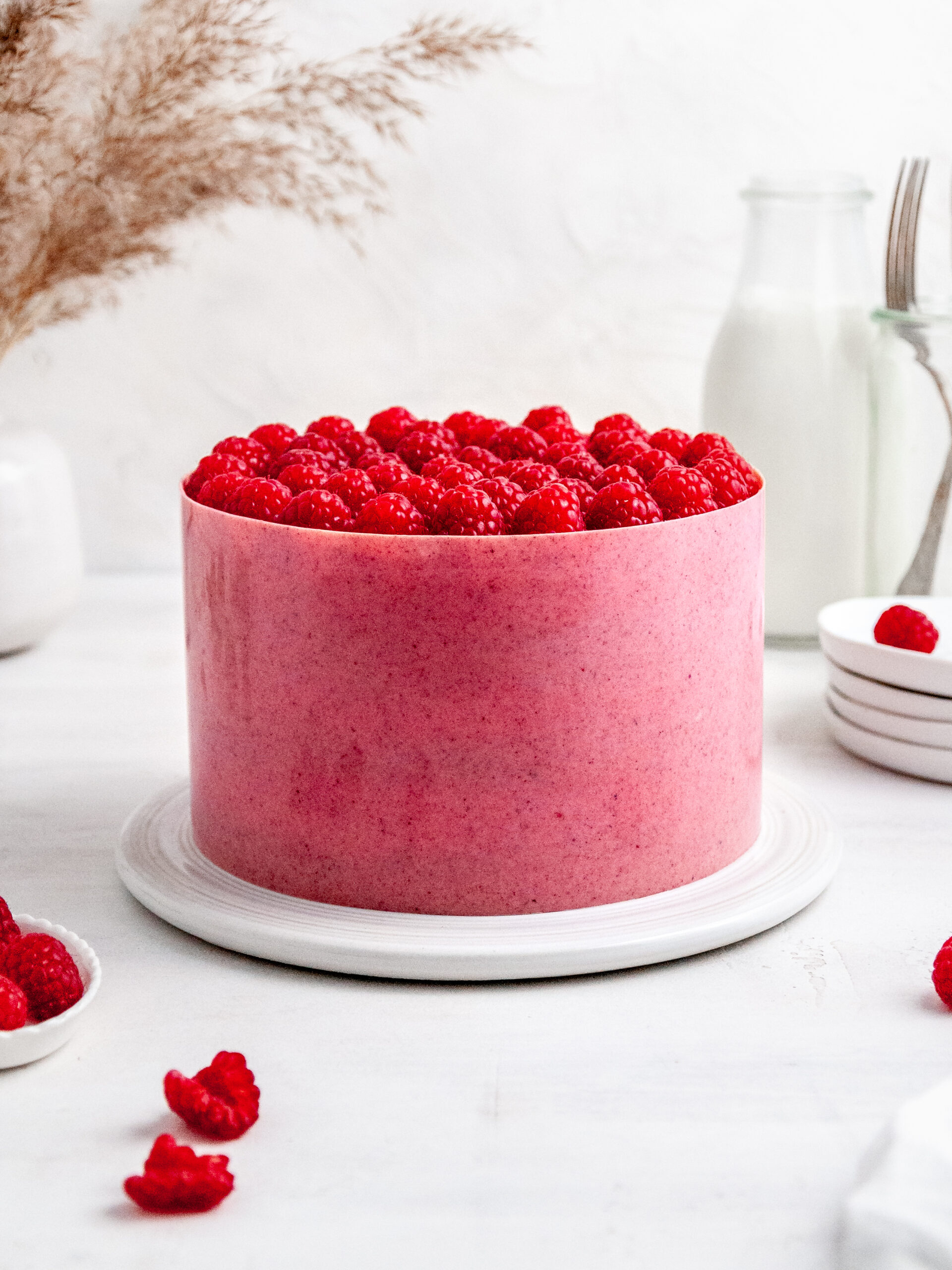 raspberry and rhubarb mousse layer cake on a cake stand.
