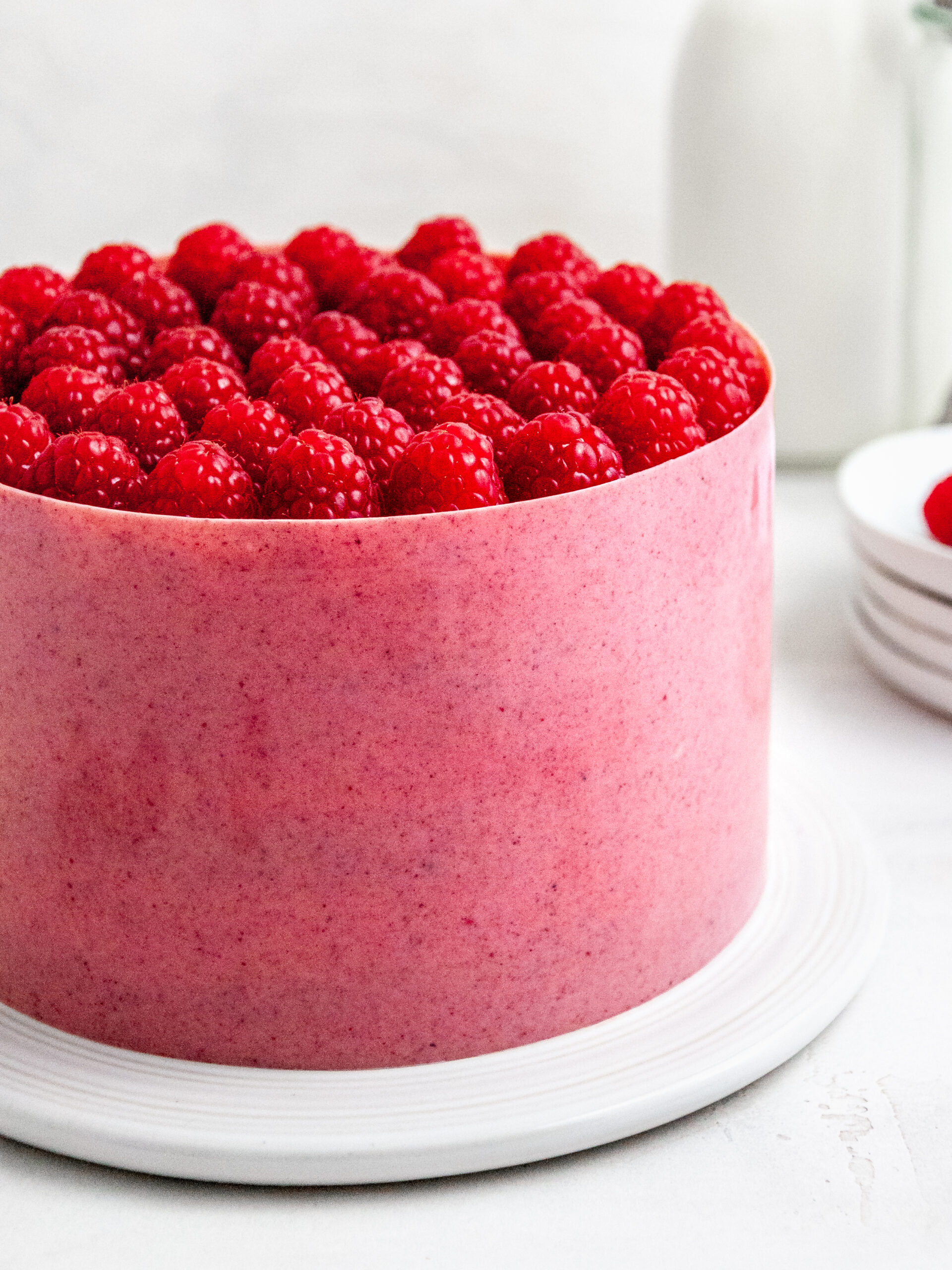 raspberry and rhubarb mousse layer cake on a cake stand 