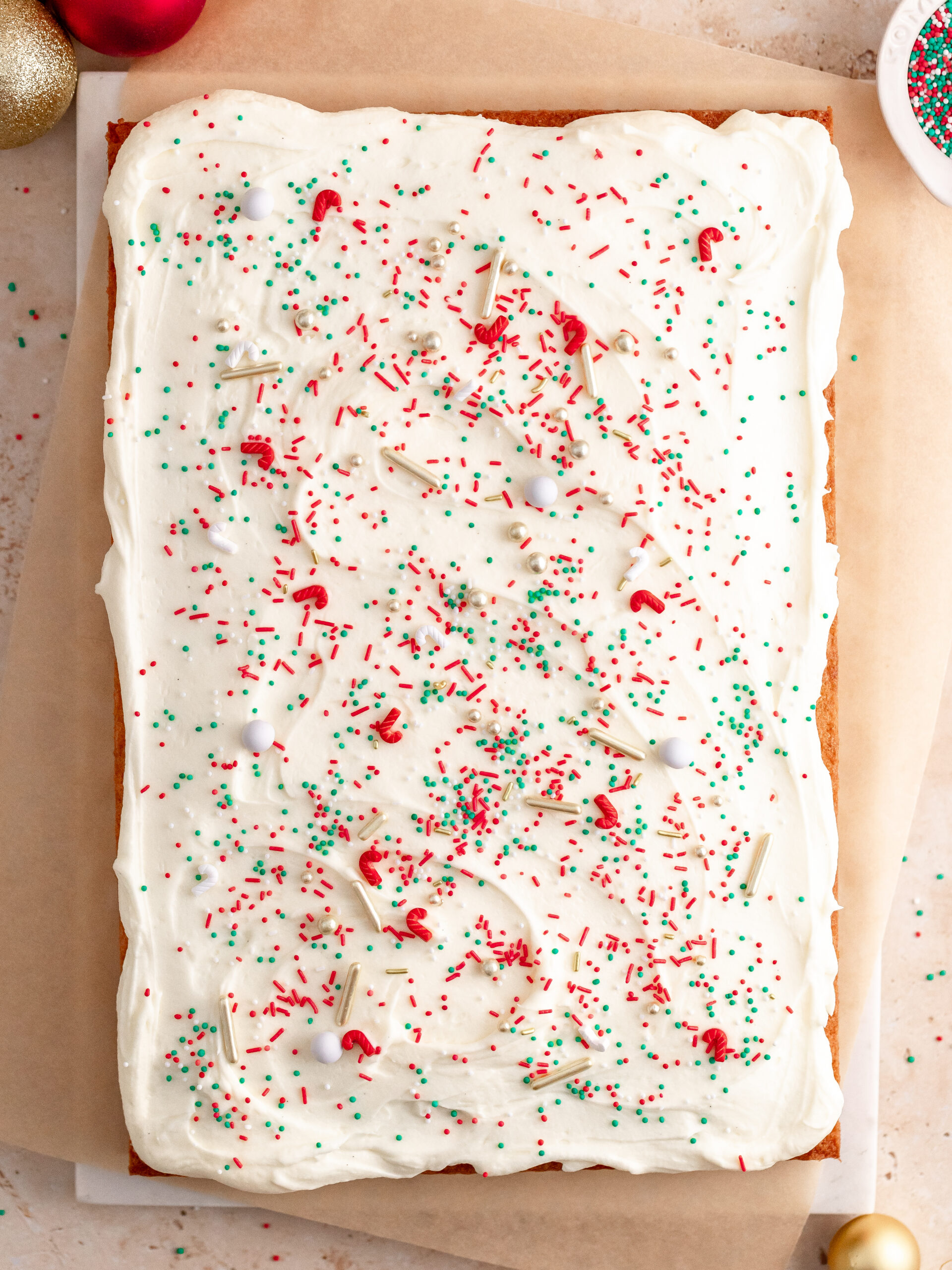 Step 5: Add the frosting to the cake and sprinkle it with Christmas sprinkles.