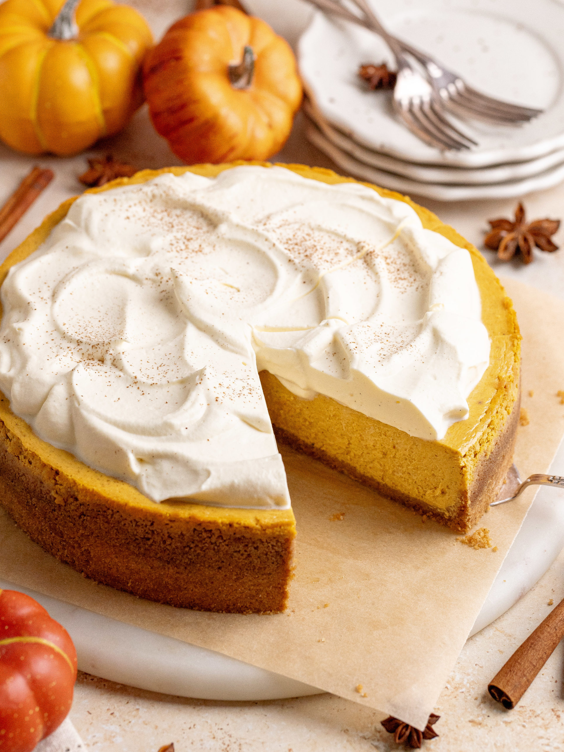 The whole pumpkin cheesecake on a serving plate.