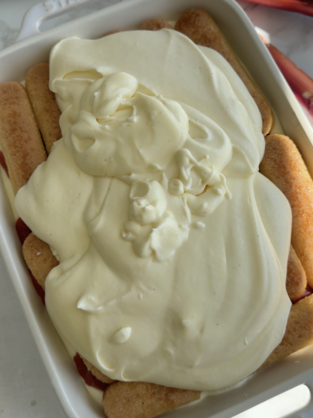 a second layer of ladyfingers and mascarpone filling in a serving dish.
