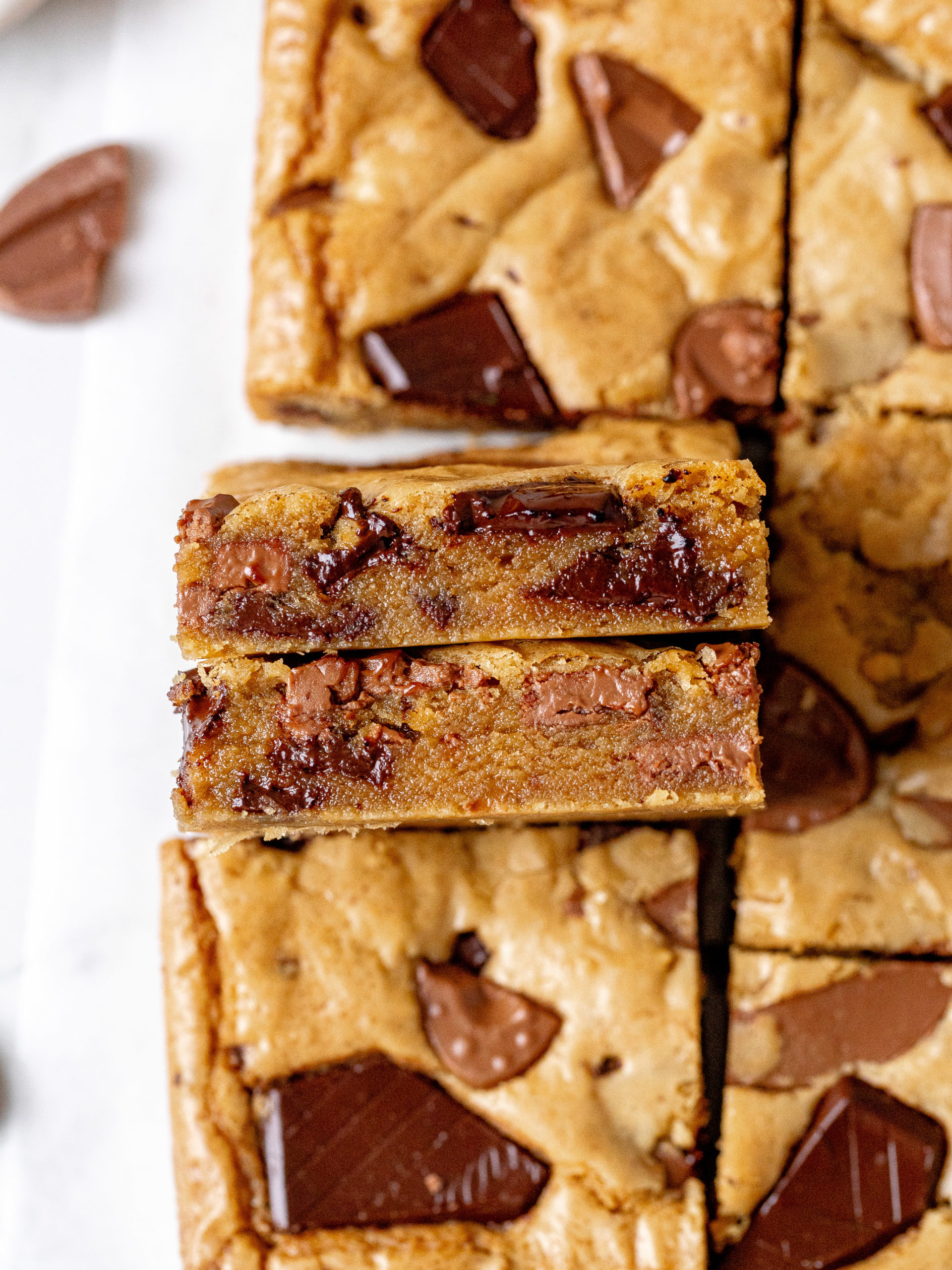 Slices of brown butter blondies with crispy edges and chocolate chunks