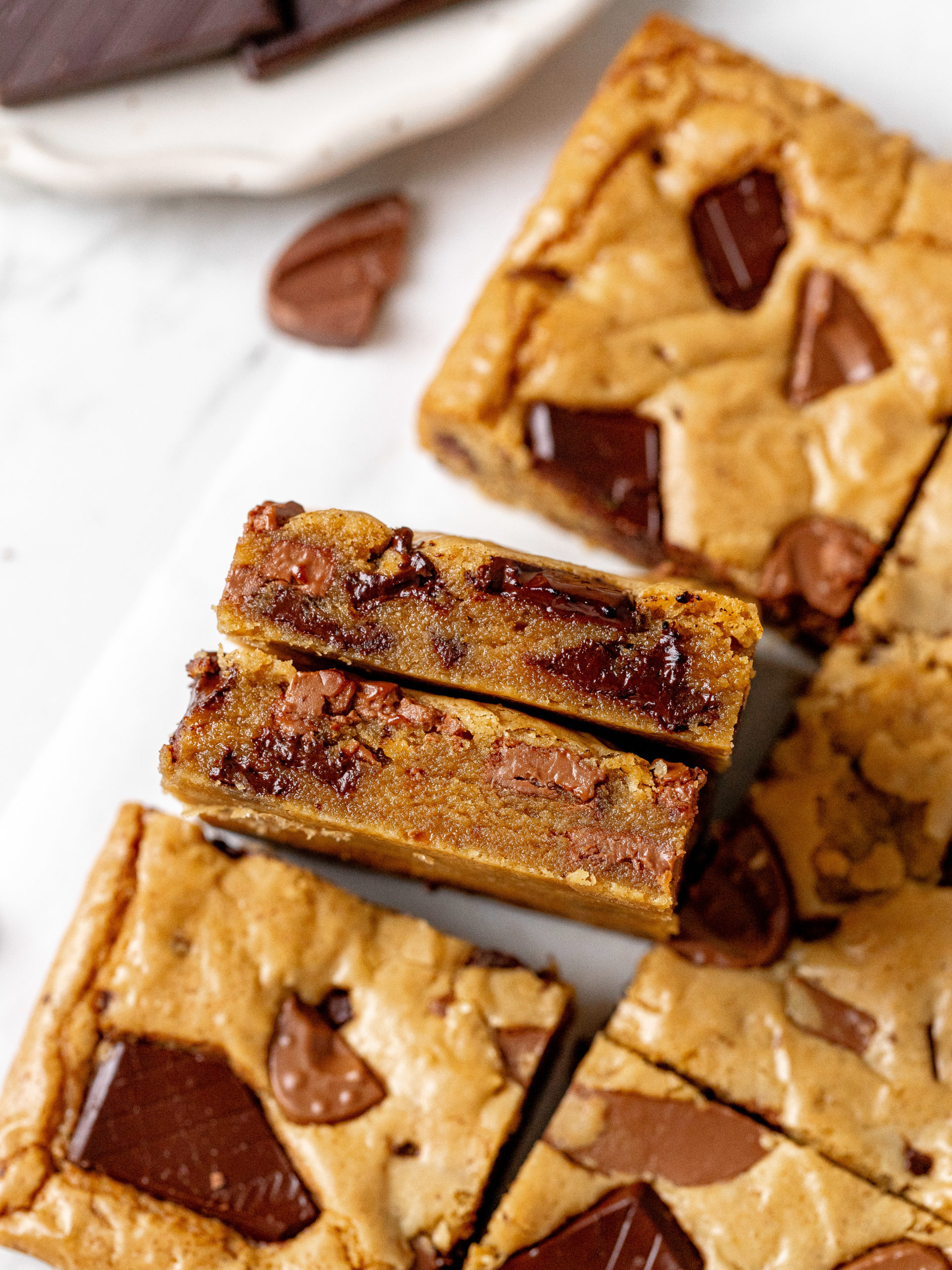 Slices of brown butter blondies with crispy edges and chocolate chunks