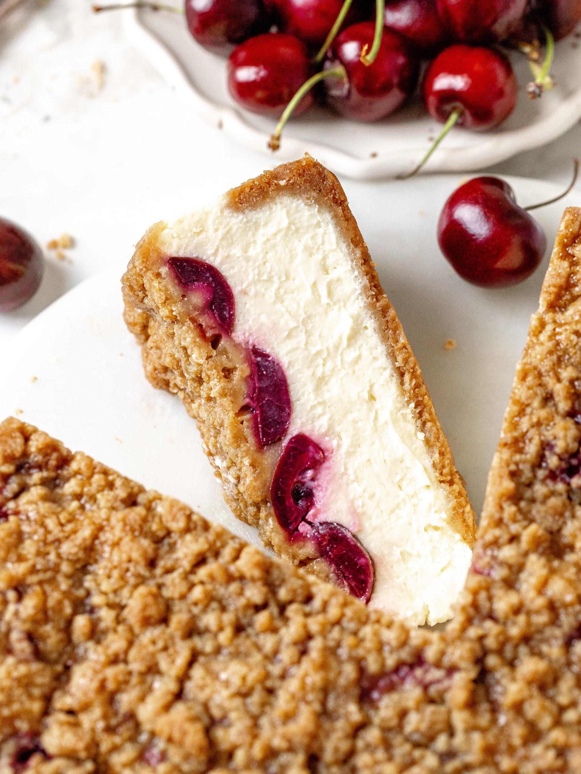 Slice of cherry crumble cheesecake