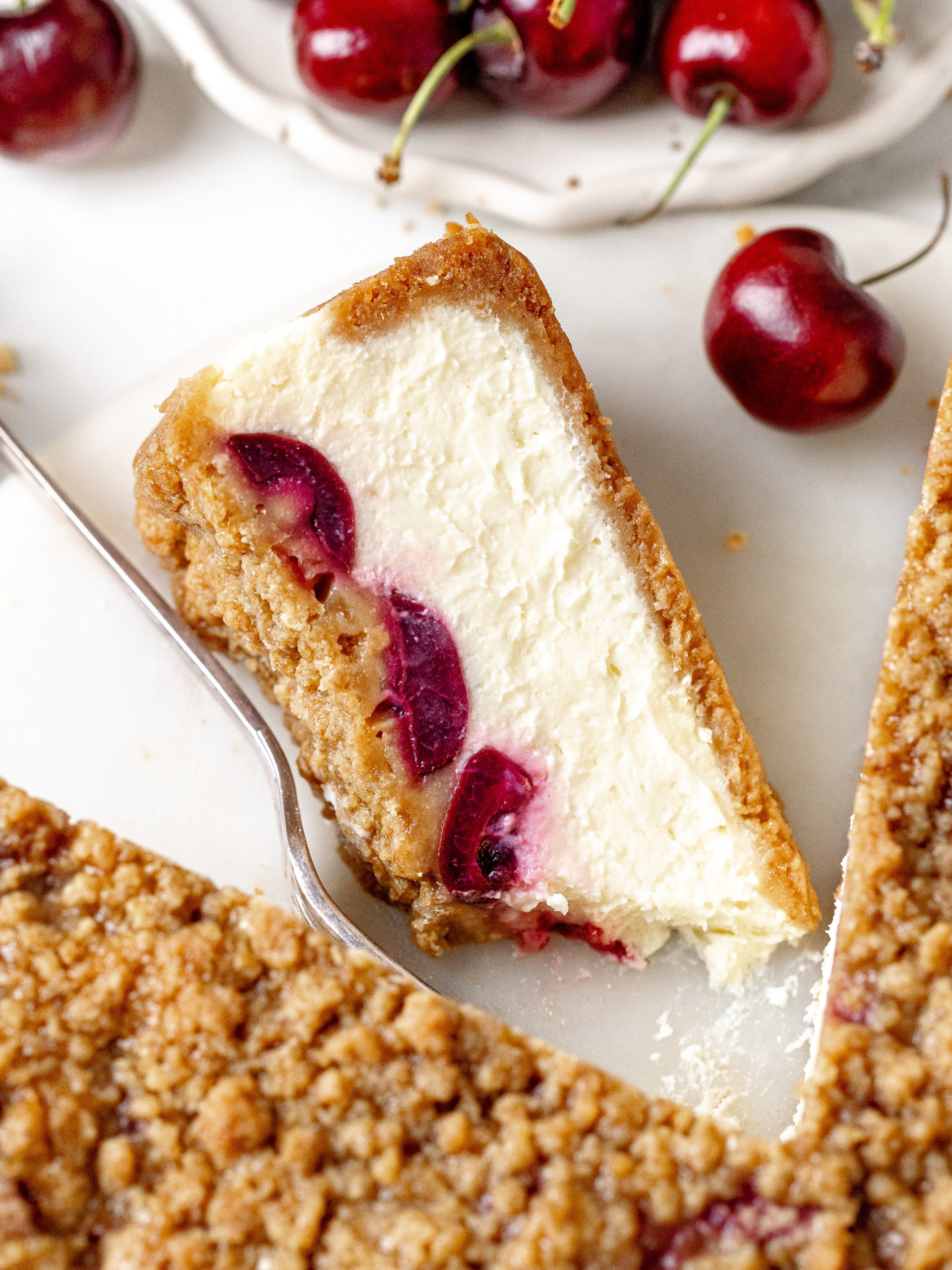 Slice of cherry crumble cheesecake