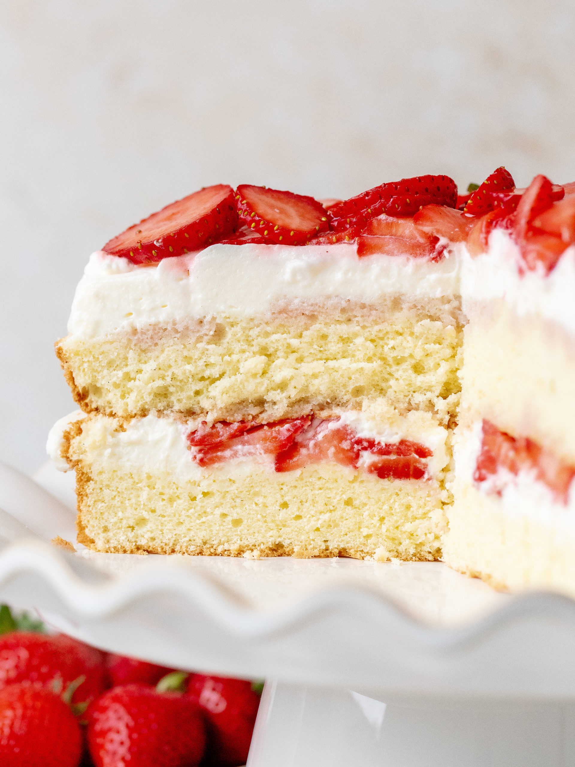 Slices cut into strawberry and cream cake.