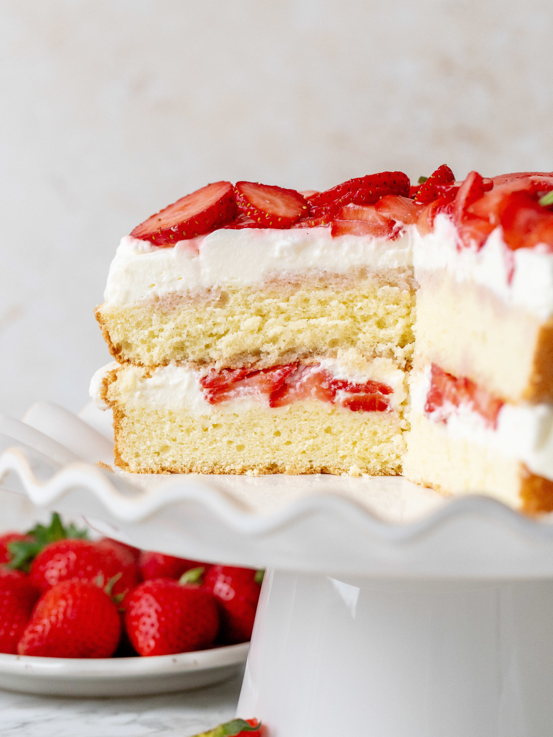 Slices cut into strawberry and cream cake.
