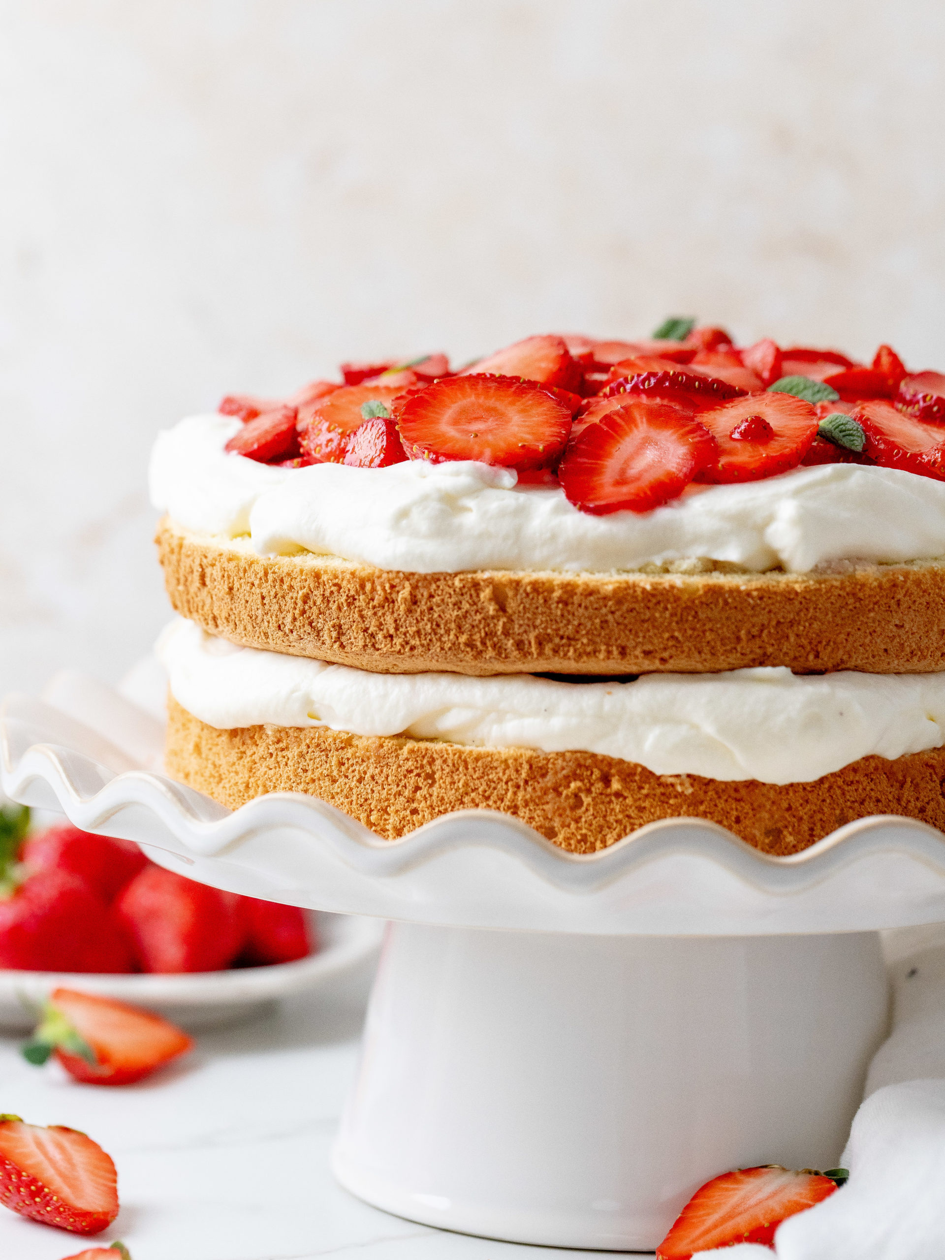 Strawberry and cream cake from the side.